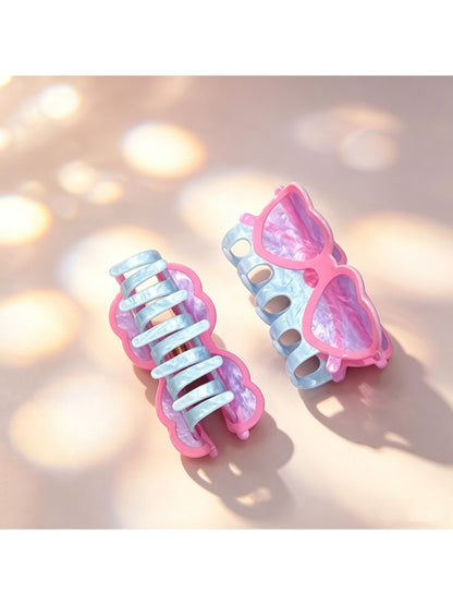 Close-up of Beau acrylic eyeglasses-shaped claw clip showing hinge detail
