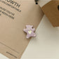 Minimalist rose hair tie and clip set shown with natural lighting