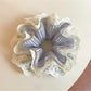 Close-up of Gifty sweet double layer ruffled scrunchie in soft pastel pink fabric