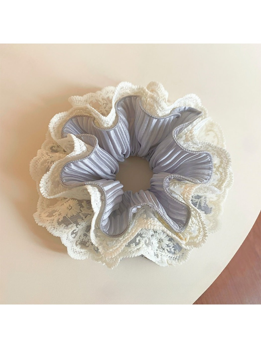 Close-up of Gifty sweet double layer ruffled scrunchie in soft pastel pink fabric