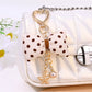 Close-up of Keypus bow keychain showing fabric texture and polka dot pattern