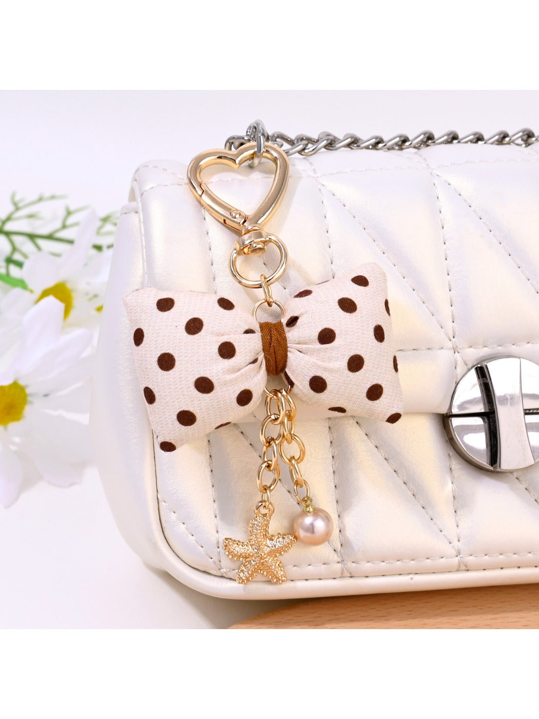Close-up of Keypus bow keychain showing fabric texture and polka dot pattern