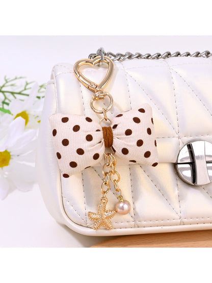 Close-up of Keypus bow keychain showing fabric texture and polka dot pattern