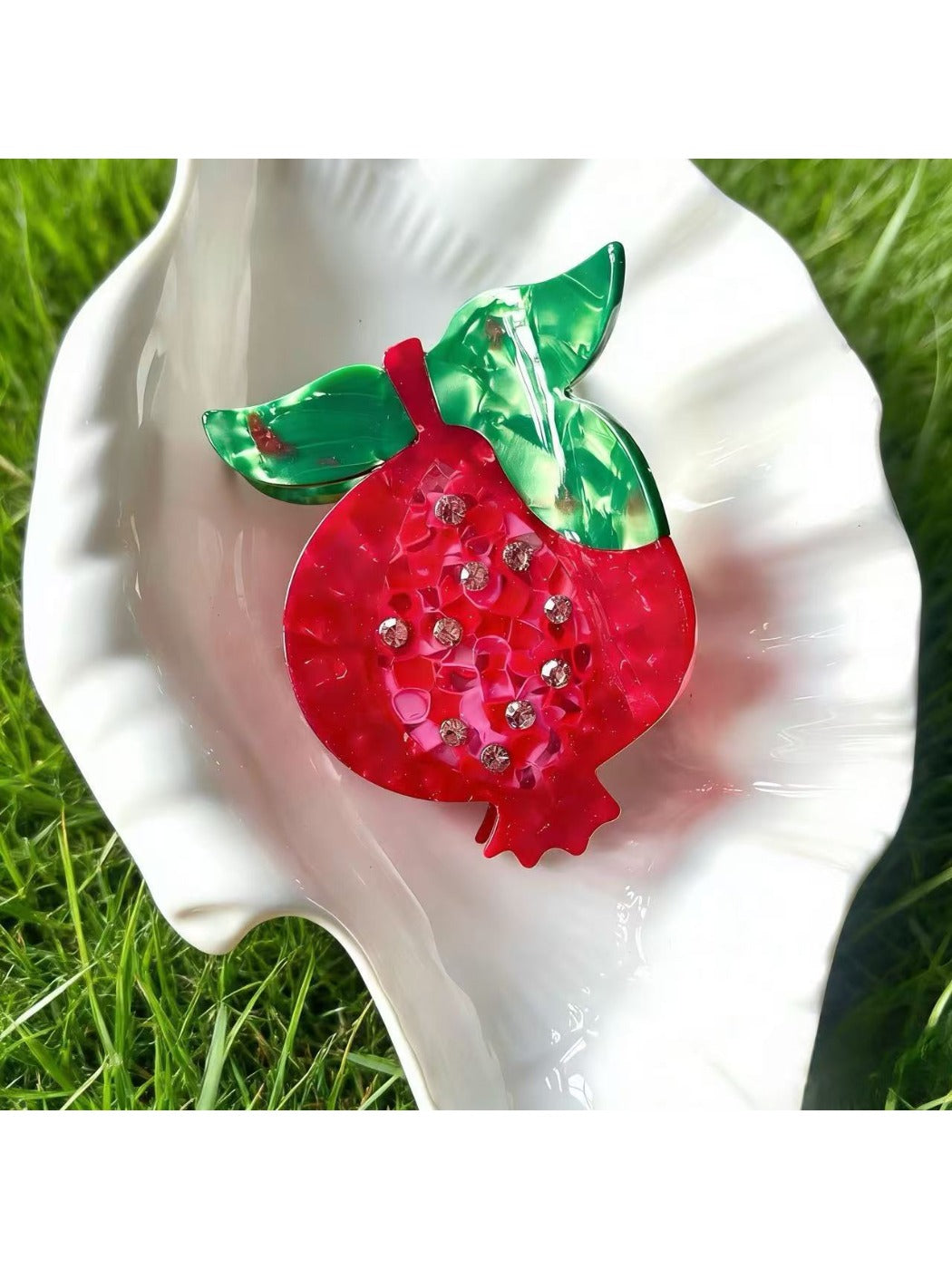 Orange fruit-shaped Beau acetate claw clip shown from top angle