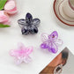 Close-up of Beau flower claw clip showing detailed petal design in multiple colors