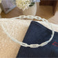 Top view of Gifty acetate chain style headband displaying smooth curved shape