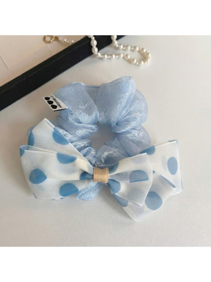 Chic hair tie with black and white polka dot bow on a white background