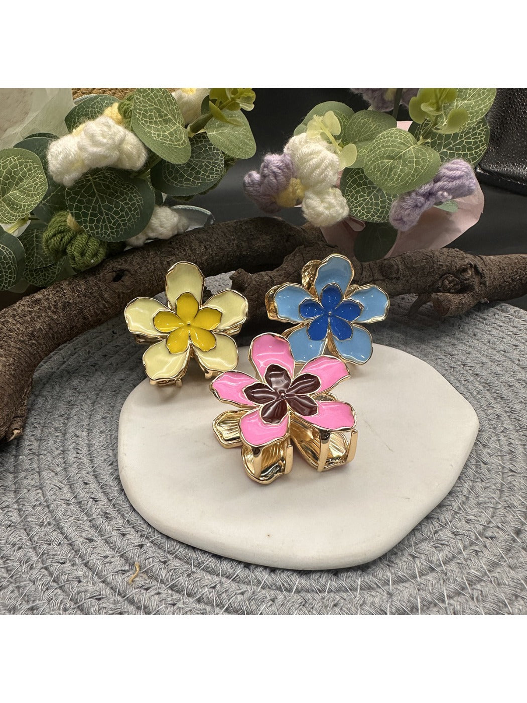 Close-up of Beau lively sunny flower hair clip with yellow petals and green leaves