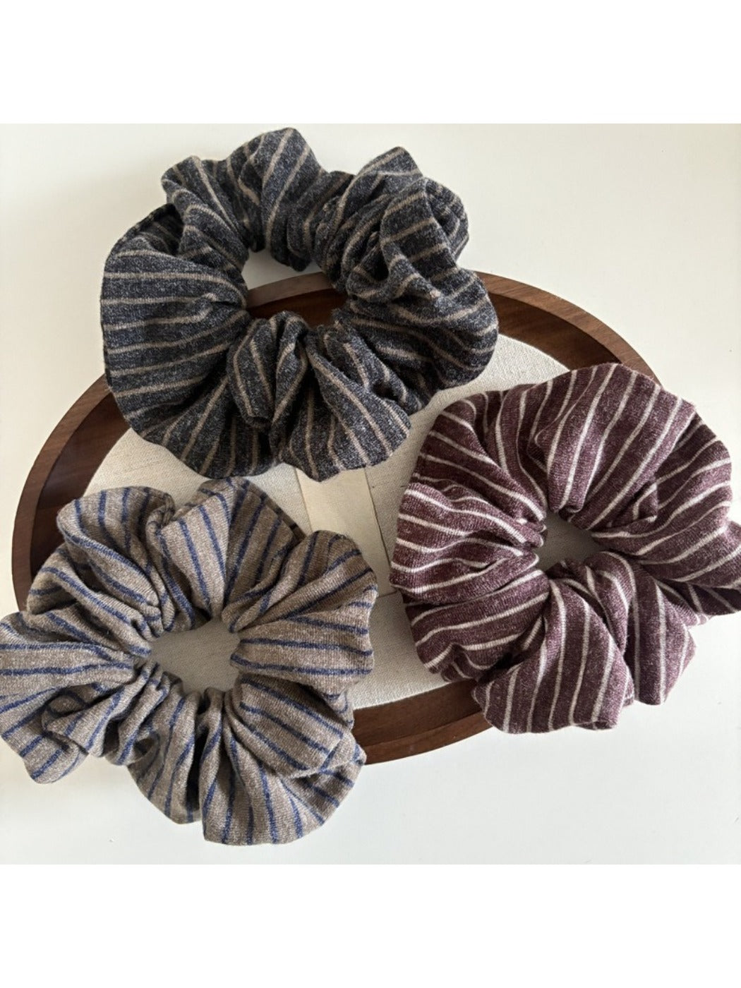 Gifty dark scrunchie with subtle stripes displayed flat