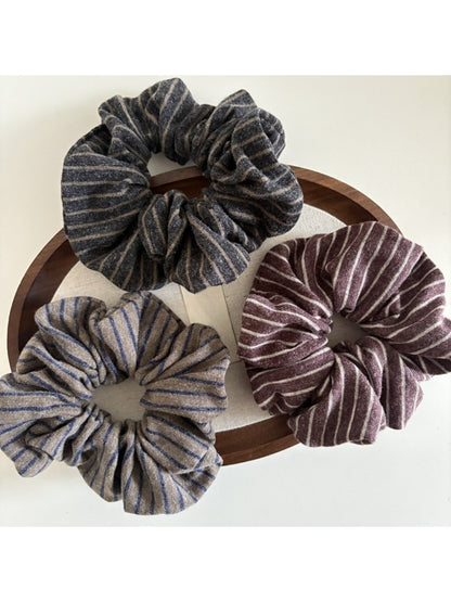 Gifty dark scrunchie with subtle stripes displayed flat