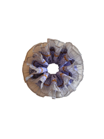 Gifty scrunchie styled on a wrist with visible lace and polka dot details