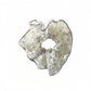 Gifty sheer tulle scrunchie displayed on a flat surface, showcasing its translucent fabric and floral print