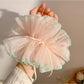 Gifty ruffle scrunchie styled on a wrist with delicate ruffled edges