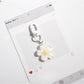 Flower-shaped keychain displayed with other colorful accessories