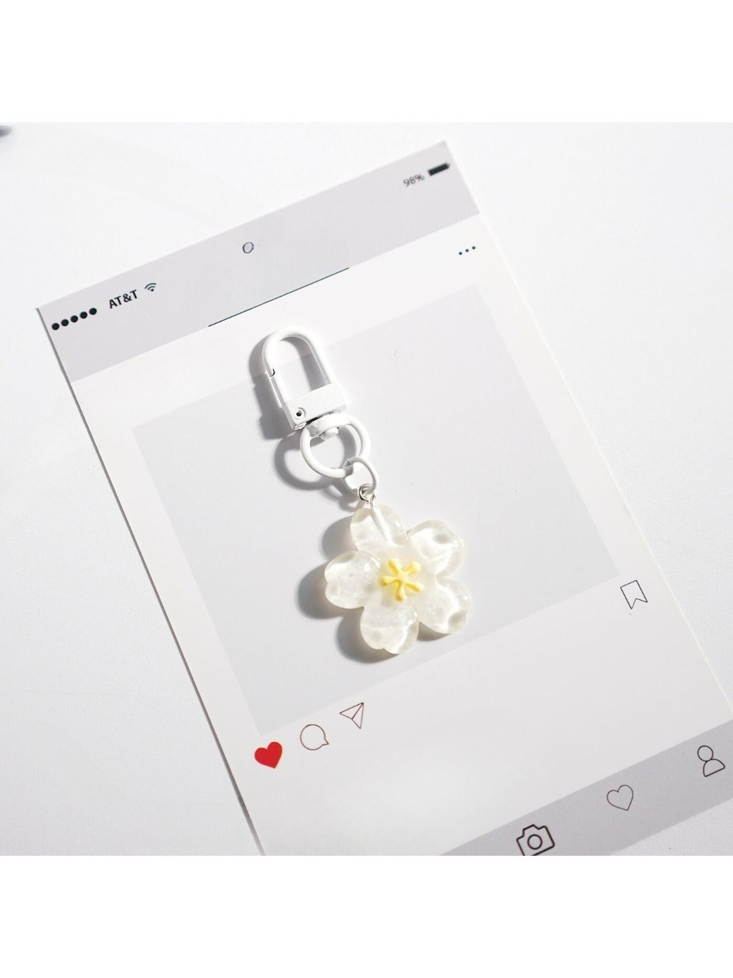 Flower-shaped keychain displayed with other colorful accessories