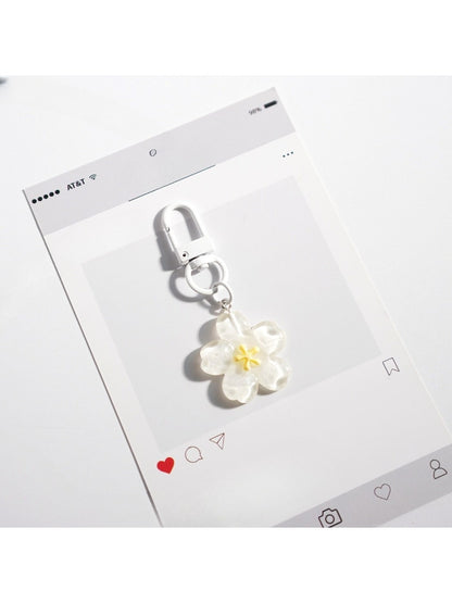 Flower-shaped keychain displayed with other colorful accessories