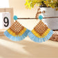 Vintage square raffia drop earrings displayed in a jewelry box with soft fabric lining