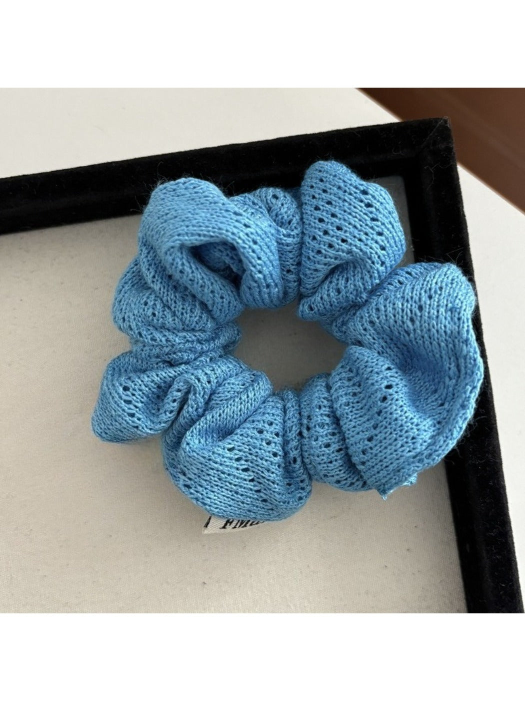 Gifty Lazy Style scrunchie styled in a ponytail, showcasing its decorative openwork