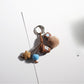 Brown tone cartoon keychain attached to a set of keys