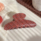 Top view of Beau plaid hair claw clip with red strawberry print