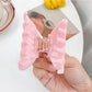 Beau hair claw clip holding thick brown hair in a half-up hairstyle