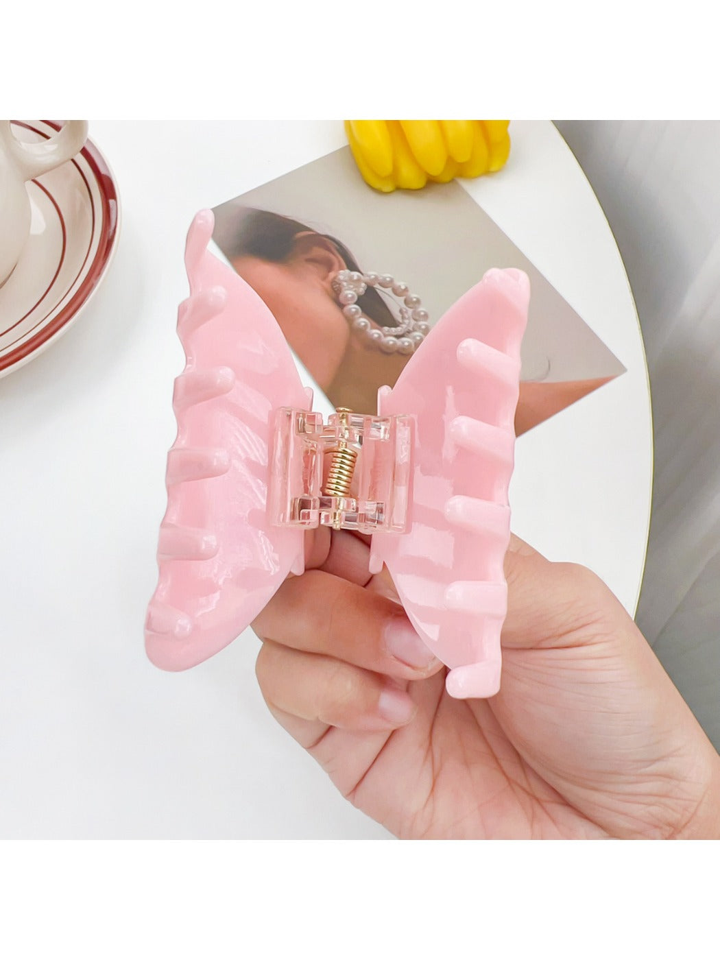 Beau hair claw clip holding thick brown hair in a half-up hairstyle