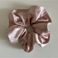 Side angle of Gifty satin scrunchie emphasizing thickness and lustrous finish