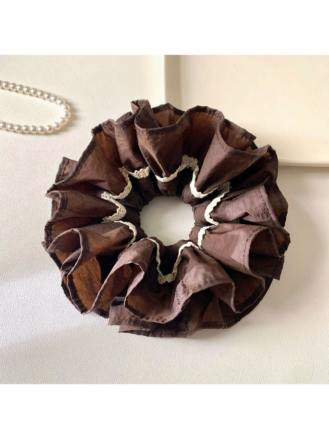 Close-up of Gifty vintage dark double layered scrunchie on white background