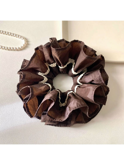 Close-up of Gifty vintage dark double layered scrunchie on white background