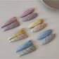 Close-up of Beau oval hair clip showing vibrant color pattern and smooth finish