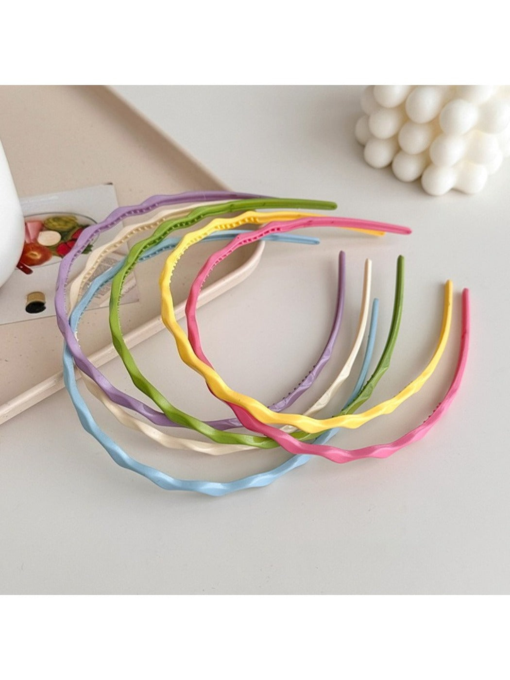 Gifty sweet solid color wavy headband in soft pink fabric on white background