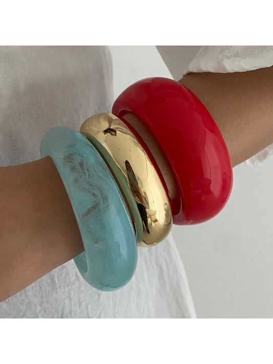 Lovra wide round bangle bracelet on white background showing smooth polished surface