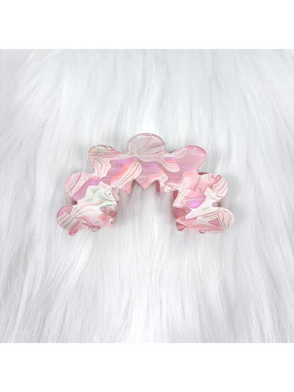 Beau wavy pink hair clip styled in model's hair from back angle