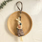 Bunny pendant keychain displayed with other minimalist accessories
