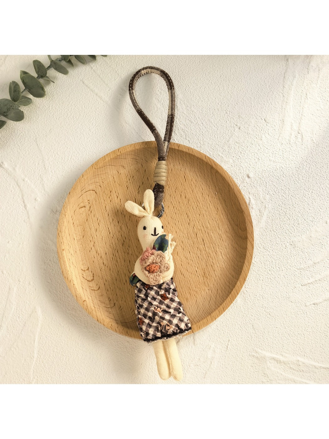Bunny pendant keychain displayed with other minimalist accessories