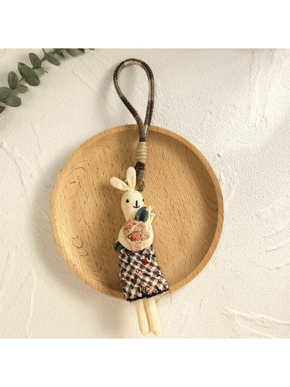 Bunny pendant keychain displayed with other minimalist accessories