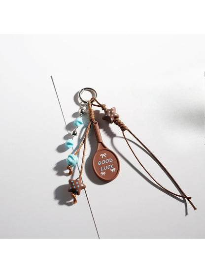 Brown tone cartoon keychain shown from the back side