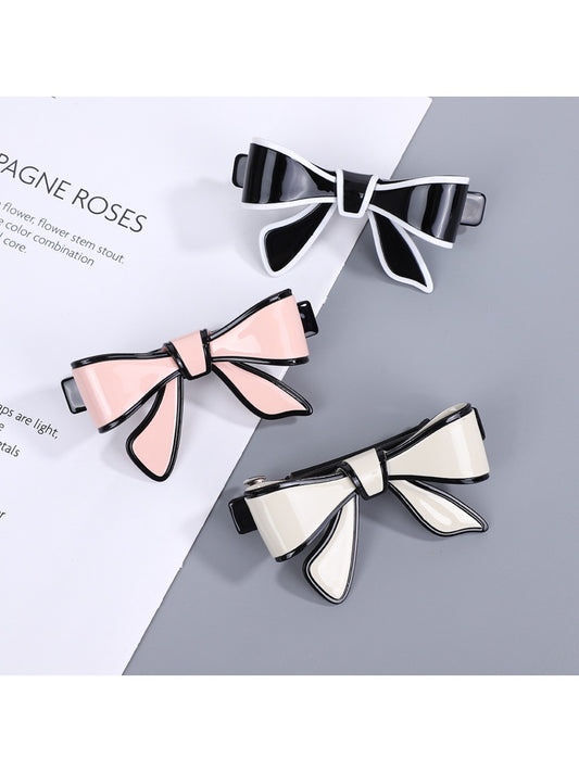 Beau stylish bow hair clip in soft pink fabric on white background