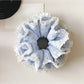 Gifty polka dot double layer lace scrunchie in black and white on a white background