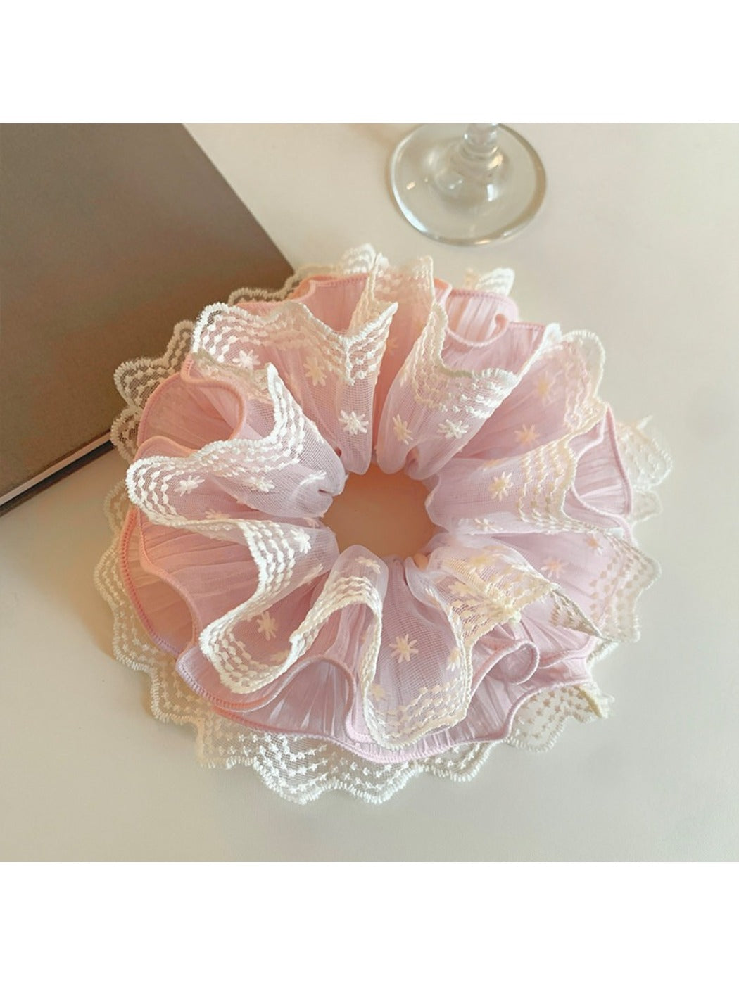 Flat lay of Gifty ruffled scrunchie highlighting its texture and colorful print