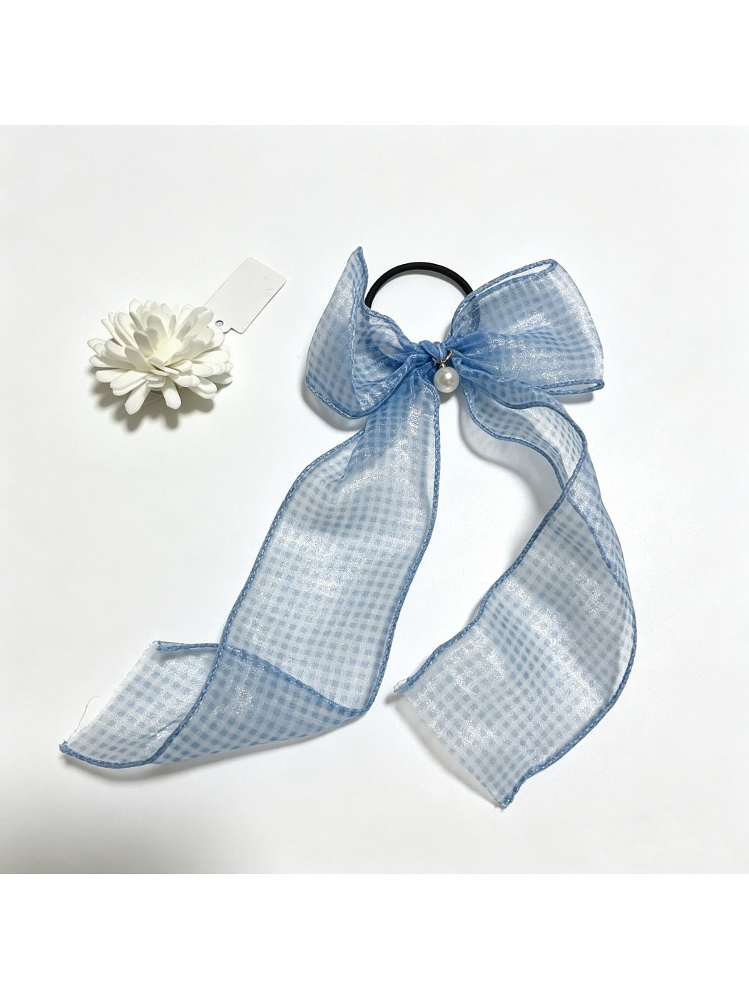 Plaid tulle bow hair tie styled in a ponytail on a model with brown hair