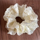 Gifty lace scrunchie paired with matching lace accessories on a table