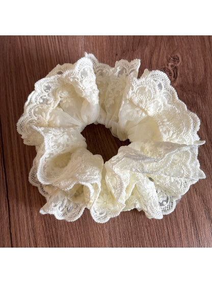 Gifty lace scrunchie paired with matching lace accessories on a table