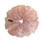 Pink floral tulle scrunchie displayed on a flat surface with soft lighting