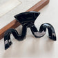 Top view of Beau wave-shaped hair claw clip showing curved teeth