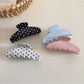 Close-up of Beau hair clip highlighting polka dot pattern and acetate material texture