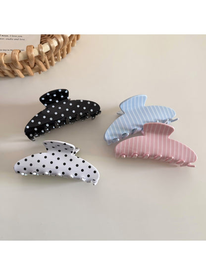 Close-up of Beau hair clip highlighting polka dot pattern and acetate material texture