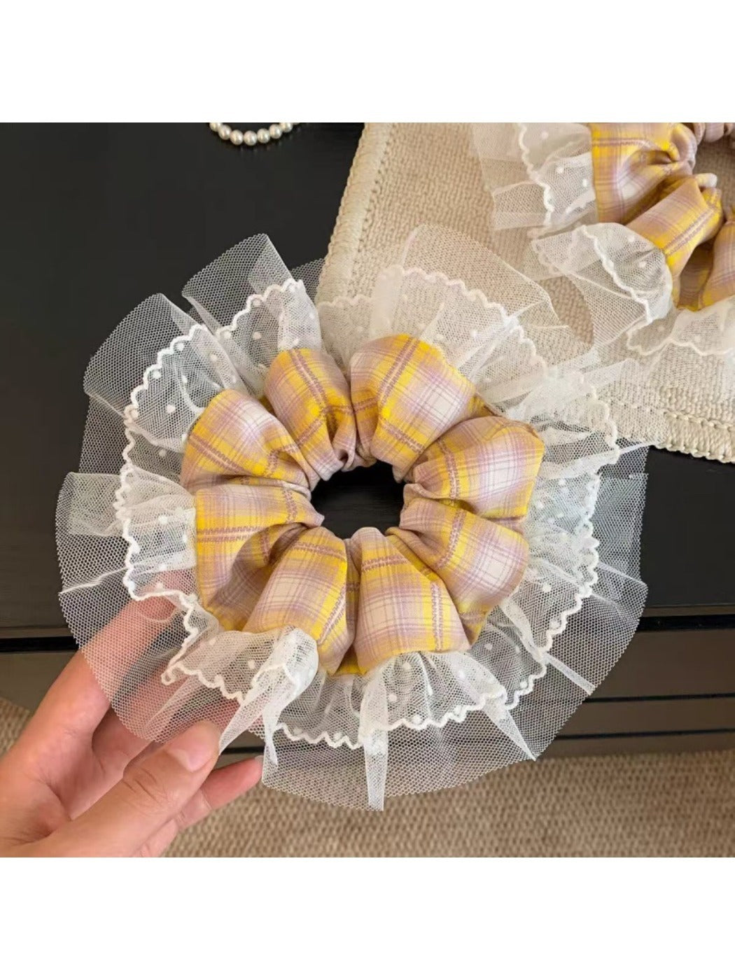 Yellow plaid scrunchie styled in a ponytail on a model