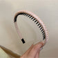Gifty headband folded to display its flexibility and fabric quality