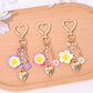 Heart-shaped flower bag charm keychain in red with gold hardware
